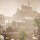 The titular forgotten city sits awash in light. Trees mark its thin streets and aqueducts, while Greek and Roman architecture mingle in the distance.